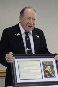 Brother Cummisky displays his diploma