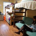 Student studying in Flores Hall dorm room