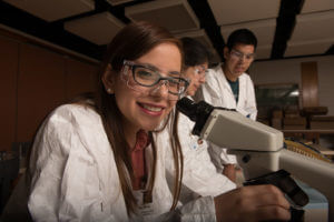 Biology student using a microscope