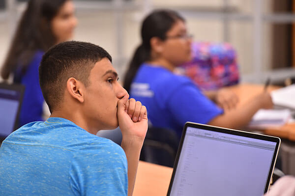 Computer Science student listens in class.