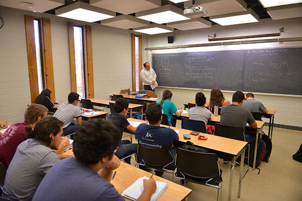 Ian Martines, Ph.D., lectures students on mathematics.