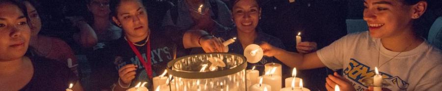 Students lighting candles at the International prayer for Peace event