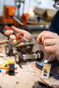 Closeup of Matteo welding a robot