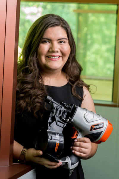 Sarah Cantu poses with a large power tool