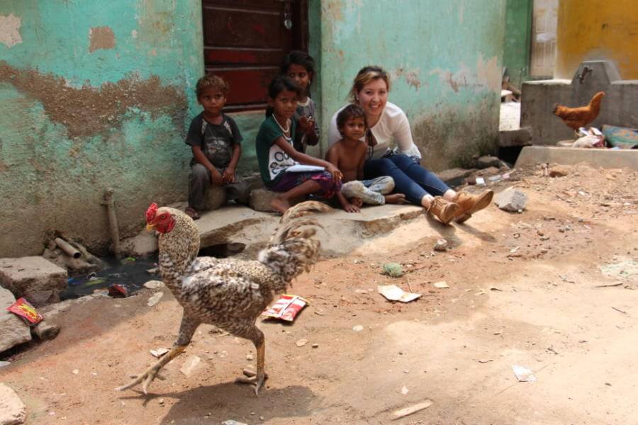 St. Mary's University student Gisell Orozco reads a book with a group of children on the streets of Bangalore's slums.