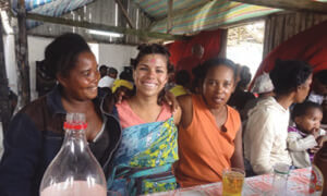 Samantha Bezdek (B.A. '10) posing with villagers in the Madagascar town she lives in