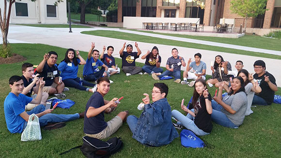 Students eat paletas and do the fangs out sign at the Zaragoza Paleta Social.