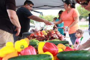 Woman purchases vegetables at the Mobile Mercado at St. Mary's on Oct. 7, 2016.