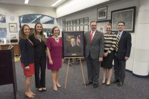 Judge David Ezra stands next to his new portrait.