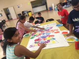 Children finger painting at the Summer of Service Program.