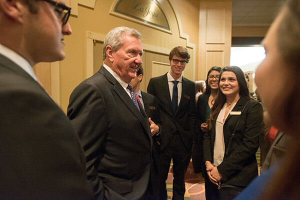 Bill Greehey speaks with Greehey Scholars at the 2016 Business Week awards dinner.