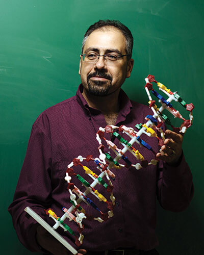 Dr. Galeleldeen with a model of DNA