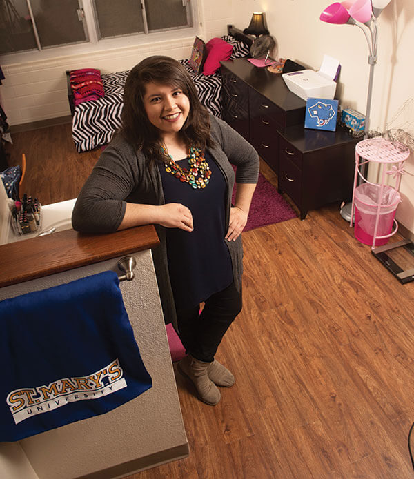 Paige Gandara-Valderas poses inside her room in Chaminade.