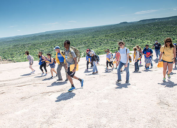 Students walking to the summit of Enchanted Rock. 