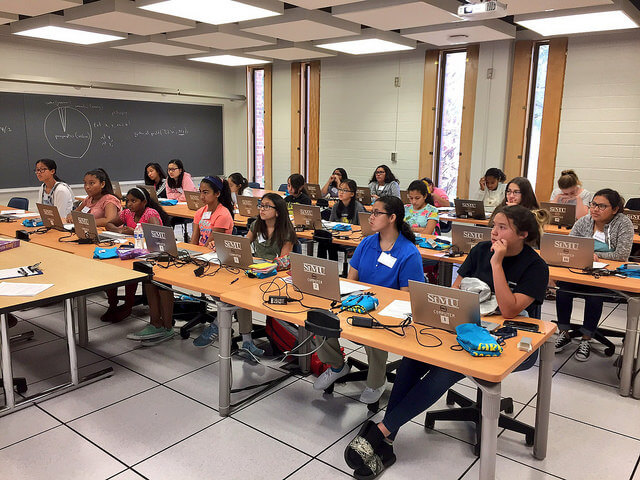 Computer science classroom full of girls learning how to code at summer camp