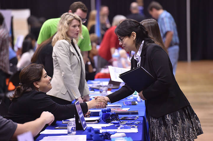 Student meeting with an employer at a job fair