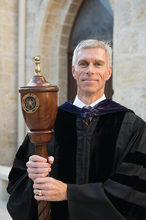 Assistant Dean Mike Barry holds the mace at a law school event.