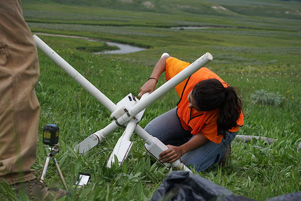 Rebeca Gurrola sets up equipment at Yellowstone National Park.