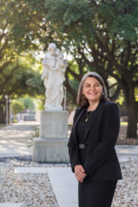 Alicia Tait stands in front of statue.