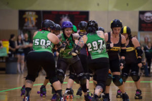 Samantha Franklin fights off roller derby opponents.