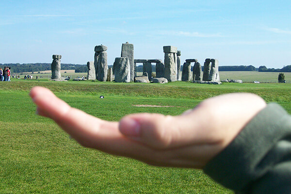 Hand appearing to "hold" Stonehenge