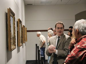 Faculty and visitors look at Gentilz paintings