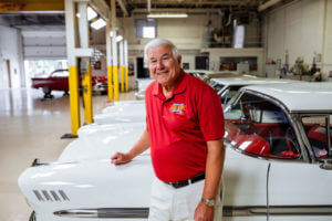 Car collector John Sieffert stands in front of his cars in his garage.
