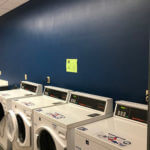 View of four industrial washing machines in Dougherty Hall