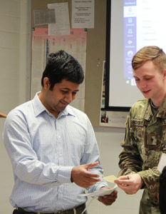 Sourav Roy, Ph.D., talks with student.