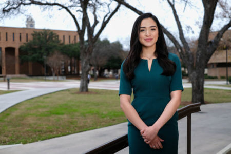 Leslie Alvarez stands in front of the law building