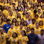 Freshmen students wear matching yellow shirts.