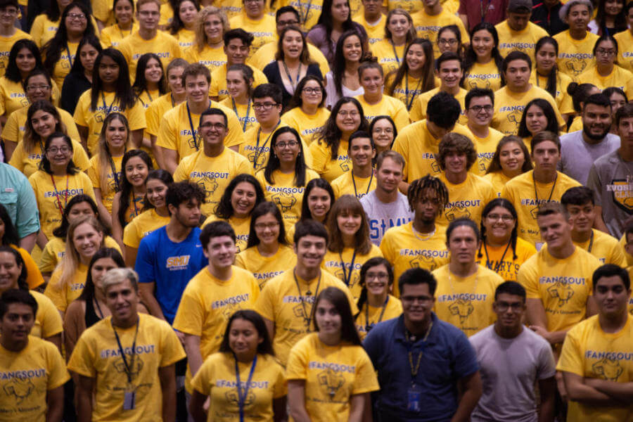 Freshmen students wear matching yellow shirts.