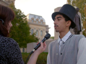 Andre Grajeda helps create a Day of the Dead altar to Lincoln and is interviewed by media.