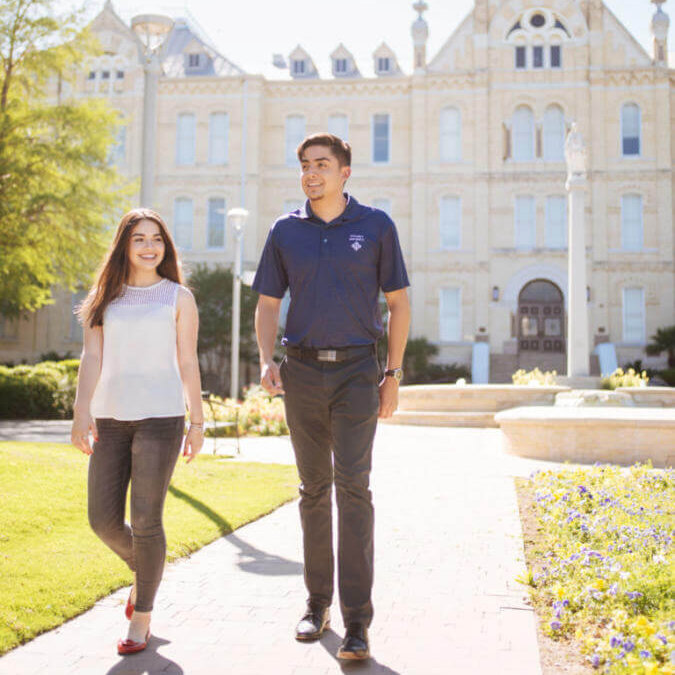St. Mary's University students take a stroll in front of St. Louis Hall in San Antonio, Texas.