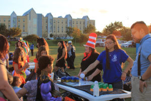 Students in costumes play games with area children at Boo Bash 2018.