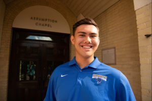 AJ Klutho stands near Assumption Chapel.