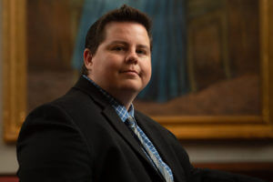 Afton Cavanaugh sits in the Sarita Kenedy East Law Library Rare Book Room.