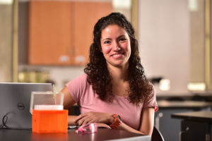 Alexis Salazar sits in a biology lab.