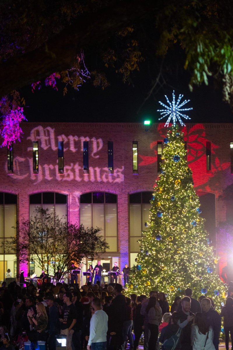 St. Mary's alumni and friends celebrate around the Christmas tree in Alkek Plaza in 2018.