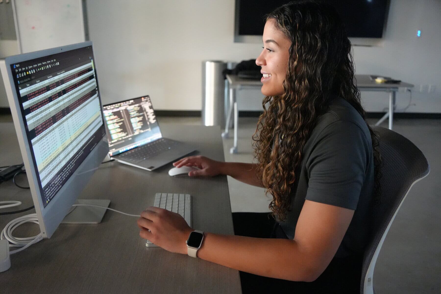 Smiling student using computer