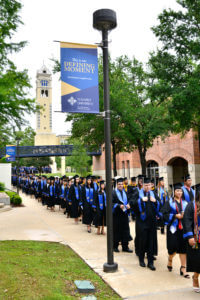 Students walk to their Commencement Ceremony in May 2019.