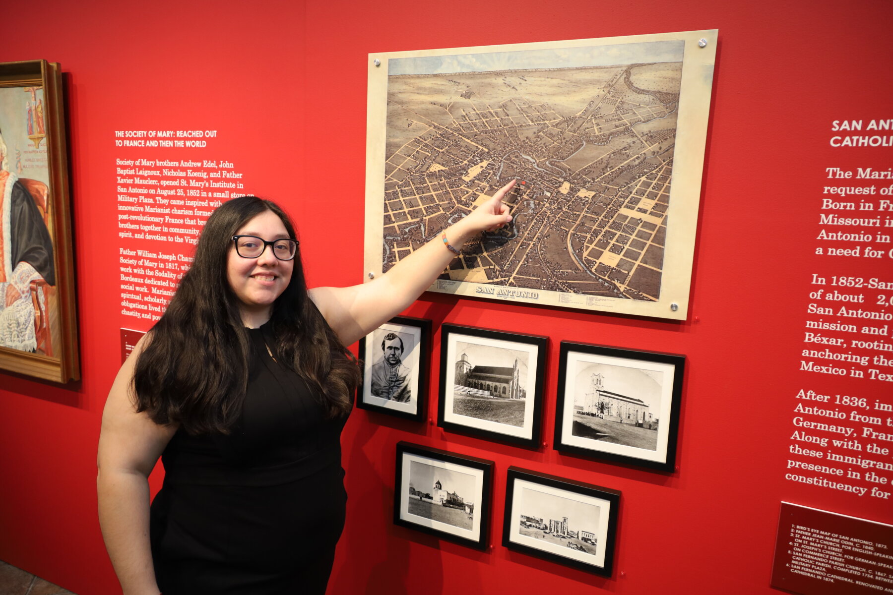Student points to a historic photo of St. Mary's University.