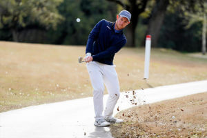 Jake Stevenson strikes a golf ball.