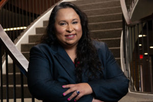 Katherine Cabello-Flores stands on the stairs in the Raba Building.