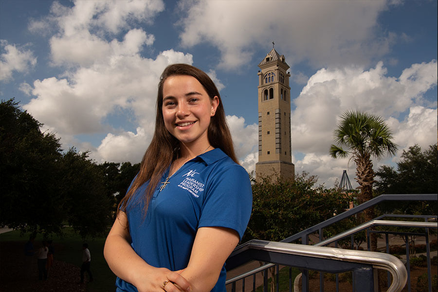Laura Dicun stands with the Bell Tower behind her.