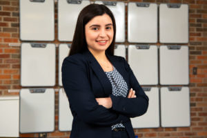 Magdalena Olivas stands in a School of Business classroom.