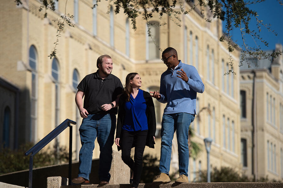 Law students chat while walking by Reinbolt Hall.