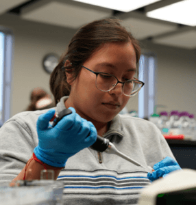 Biology student using equipment.