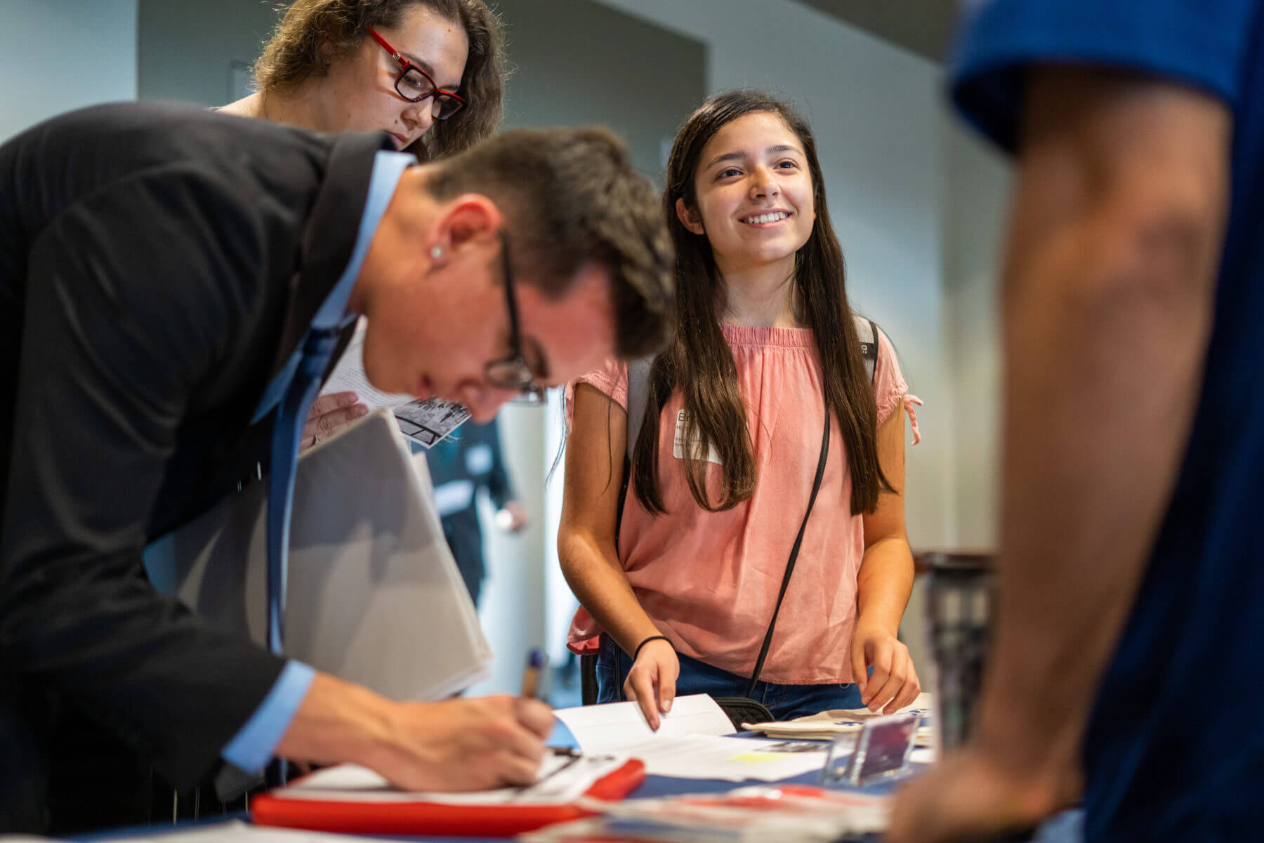 Students network with a potential employer at a career fair.