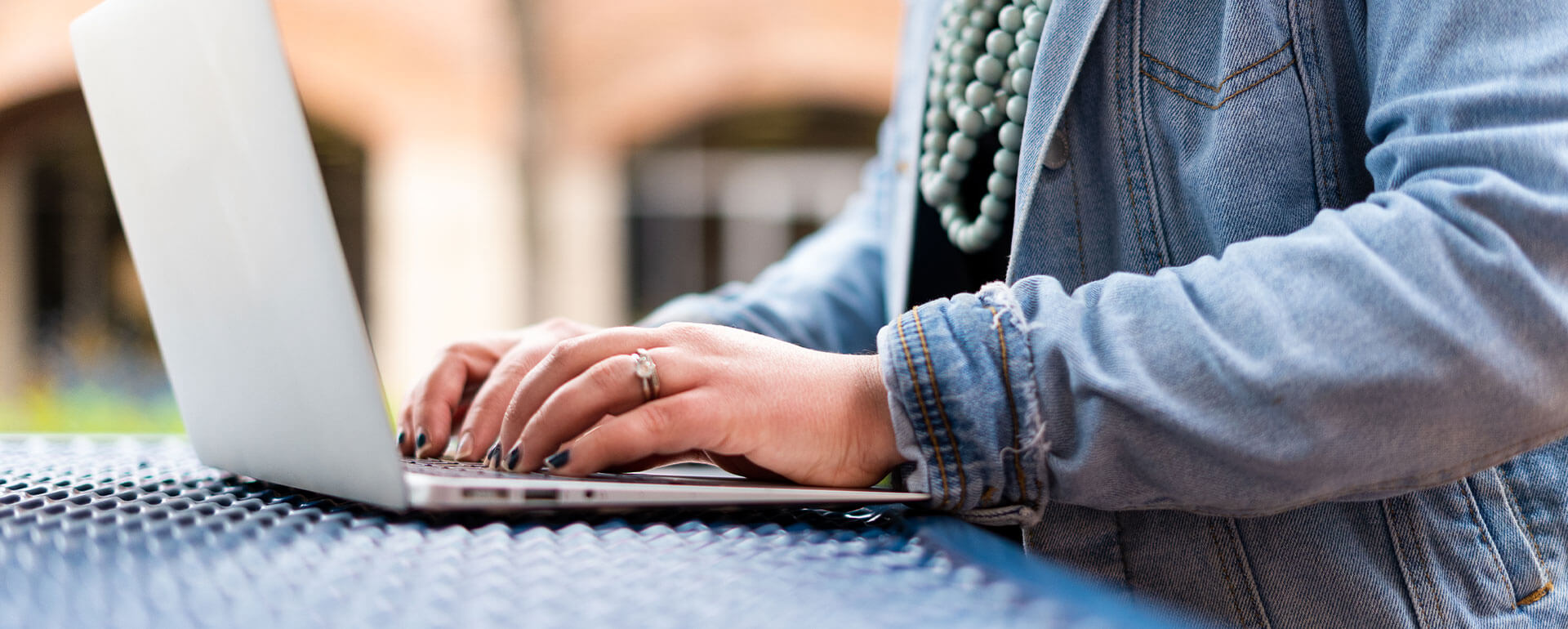 A female student types on a laptop.